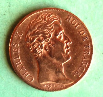 a close up of a penny on a green surface