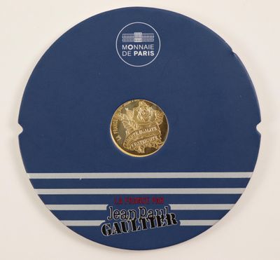 a close up of a coin on a blue and white plate