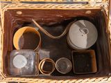 a wicker basket with various items in it on a table