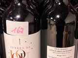several bottles of wine are lined up on a shelf in a store