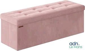 a pink bench with a cushion on top of it