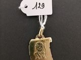 a gold plated necklace with a picture of a woman on it