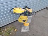 a yellow and black machine that is sitting on the ground