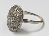 a close up of a silver ring with a diamond in it