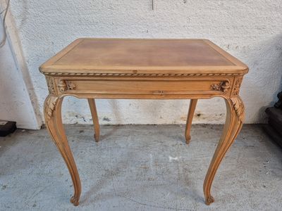 a small wooden table with a drawer on top of it