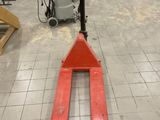 a fork lifter sitting in the middle of a room