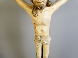 a statue of jesus on a cross with a crown on his head