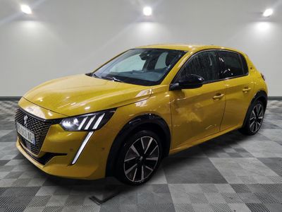 a yellow car is parked on a checkered floor in a garage
