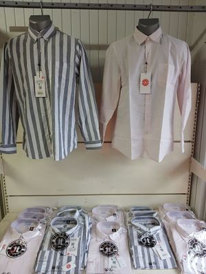 a lot of shirts and ties on display in a store