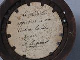 a close up of a small brown object with writing on it