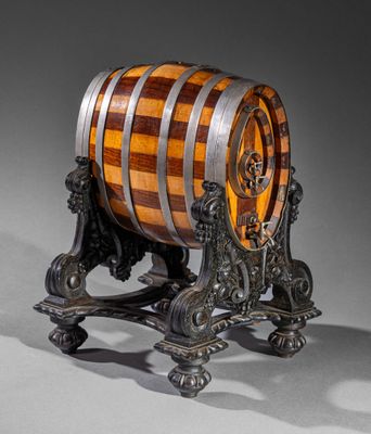 a wooden barrel sitting on a stand on a gray surface