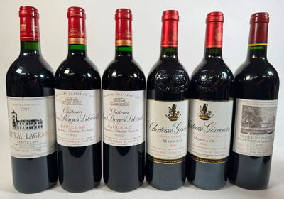 six bottles of red wine lined up in a row on a white surface