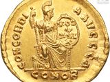 a close up of a gold coin with an image of a woman on it
