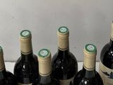 bottles of wine are lined up in a row on a table