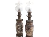 pair of asian vases with lamps on stands on a white background