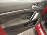 the interior of a car with the door open and the driver ' s seat down