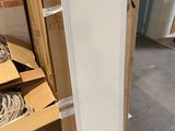 a picture of a refrigerator in the middle of a pile of boxes