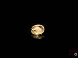 a close up of a yellow diamond on a black surface