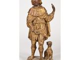 une statue en or représentant un homme avec un chien, sur fond blanc