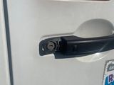 a close up of a car door handle with a sticker on it