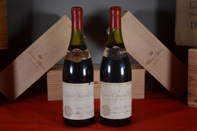 two bottles of wine sitting next to each other on a table