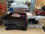a printer sitting on top of a box next to other boxes