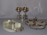 a silver plate with a silver spoon and a silver plate with a silver spoon and a silver plate with a silver spoon and a silver plate with a silver