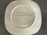 a white plate with writing on it on a table