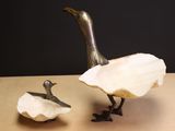 sculpture of a duck and a duckling sitting on a table