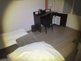 a small desk with a computer on it in a bedroom