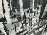 a black and white painting of a cityscape on the wall