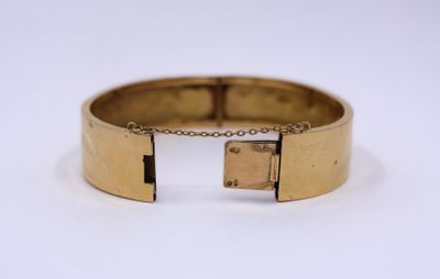 a close up of a gold bracelet with a lock on it
