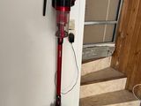 a vacuum that is sitting on the floor next to a door