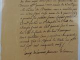 an old piece of paper with writing on it sitting on a table
