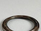 a close up of a silver ring on a white surface