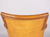 the back of a chair with a wooden frame and wicker seat