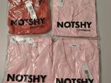 trois t-shirts roses portant les inscriptions « not shy » et « cashmere »