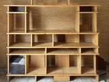 a wooden shelf with several shelves on it in a room