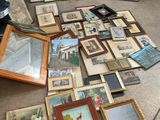 a lot of framed and unframed pictures on the floor