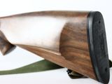 a close up of a wooden gun on a white background