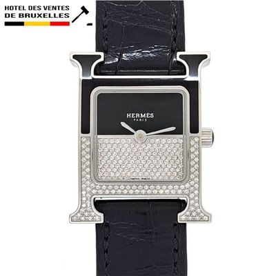 the black and white watch has diamonds on it ' s face