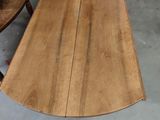 a wooden table with a curved top in the middle of a room