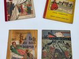 three books on a table with a white background and a yellow cover