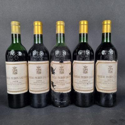 four bottles of wine are lined up in a row