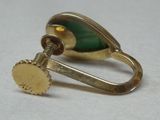 a gold ring with a green stone on it