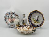 three different pieces of pottery on display on a table