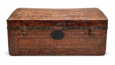 an old trunk that is sitting on a white surface