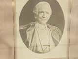 an old photograph of a man in a priest ' s robes