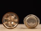 two silver knobs sitting on a wooden table