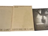 three books are stacked on top of each other on a white surface